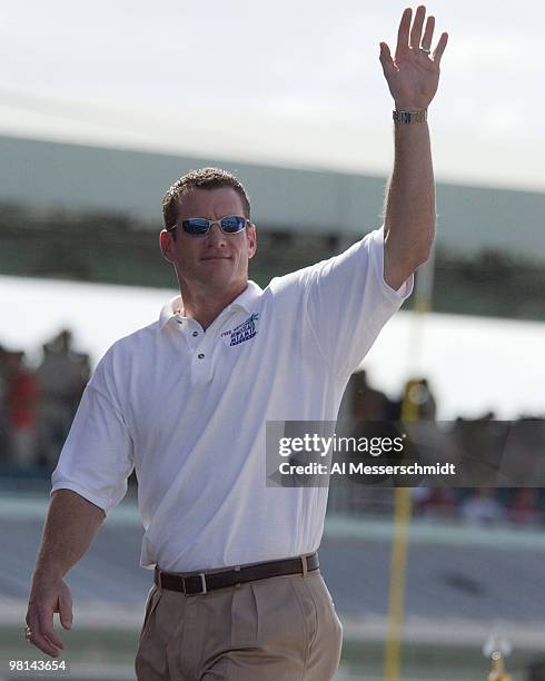 Florida Marlins Jeff Conine, an honorary race marshal, waives to the crowd before the Ford 400 Winston Cup Race, Sunday, November 16, 2003 at...