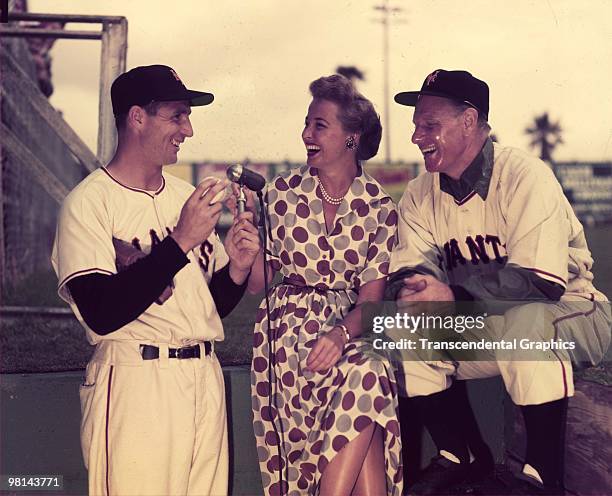 Bobby Thomson, Laraine Day, and Leo Durocher share a laugh at the microphone at the New York Giants spring training facility in Phoenix, Arizona in...