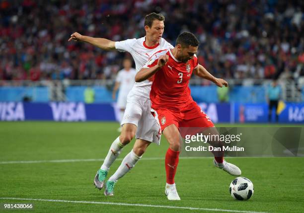 Dusko Tosic of Serbia is challenged by Stephan Lichtsteiner of Switzerland during the 2018 FIFA World Cup Russia group E match between Serbia and...