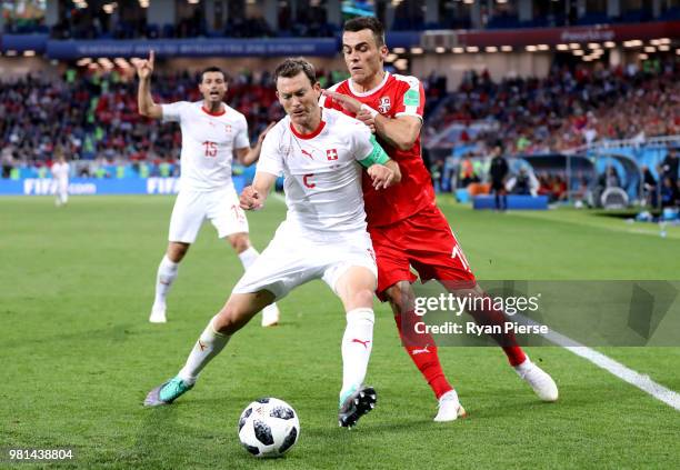 Stephan Lichtsteiner of Switzerland battles for possession with Filip Kostic of Serbia during the 2018 FIFA World Cup Russia group E match between...