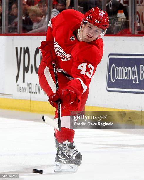 Darren Helm of the Detroit Red Wings takes a shot during an NHL game against the Minnesota Wild at Joe Louis Arena on March 26, 2010 in Detroit,...