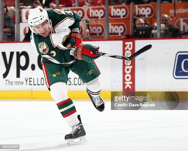 Marek Zidlicky of the Minnesota Wild takes a shot against the Detroit Red Wings during an NHL game at Joe Louis Arena on March 26, 2010 in Detroit,...