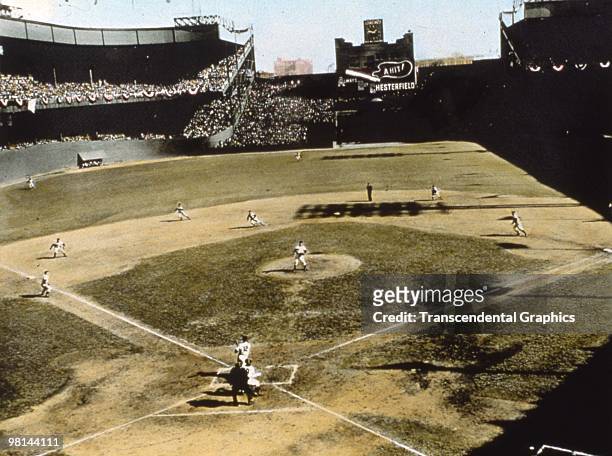 In the Polo Grounds in New York, during game 5 of the 1951 World Series Yankee second baseman Gil McDougald has just struck a grand slam home run in...