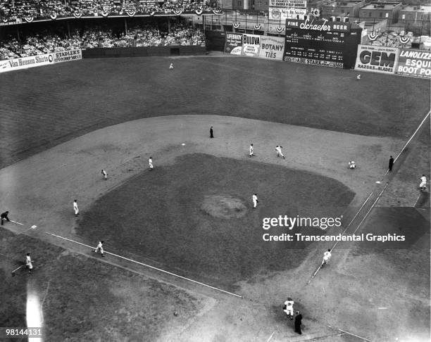 Bobby Brown of the Yankees has just driven a ball to right field and is running out a triple while driving in Henrich, Berra and DiMaggio in the...