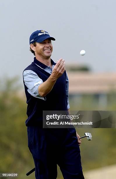 Lee Janzen tosses a golf ball to his caddy during third round competition January 31, 2004 at the 2004 FBR Open at the Tournament Players Club at...