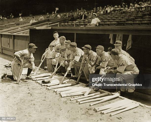 In his first year as manager, Joe McCarthy, left, gives instructions to his Chicago Cubs before they head out onto the field for batting and infield...