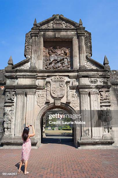 girl photographing fort santiago gate; intramuros - manila stock pictures, royalty-free photos & images