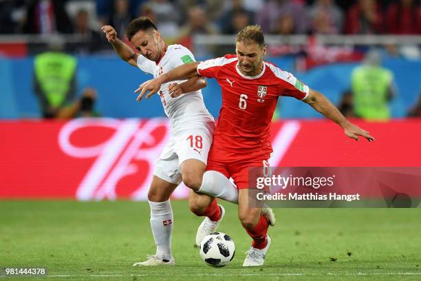 Mario Gavranovic of Switzerland battles for possession with Branislav Ivanovic of Serbia during the 2018 FIFA World Cup Russia group E match between...