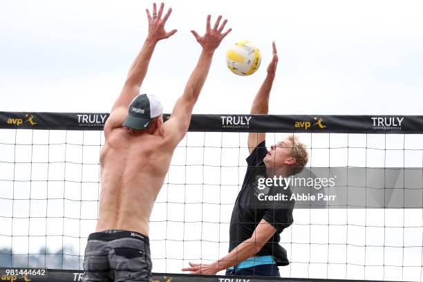 Avery Drost spikes the ball against Chaim Schalk during opening rounds of the AVP Seattle Open at Lake Sammamish State Park on June 22, 2018 in...