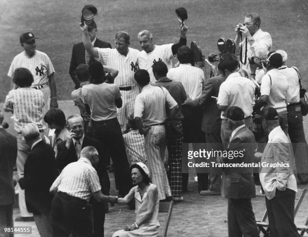 At Old Timers Day at Yankee Stadium during the season of 1969, Mickey Mantle, left with hat in the air, and Joe DiMaggio salute the crowd, as Mrs....