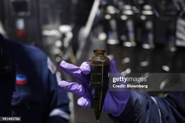 An offshore worker displays a hydrocarbon sample aboard the Chevron Corp. Jack/St. Malo deepwater oil platform in the Gulf of Mexico off the coast of...