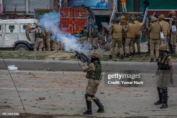 An Indian policeman fire tear gas shells at Kashmir protesters during a protest on June 22, 2018 in Srinagar, the summer capital of Indian...