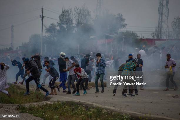 Tear gassed Kashmir protesters throw stones at Indian government forces during a protest on June 22, 2018 in Srinagar, the summer capital of Indian...