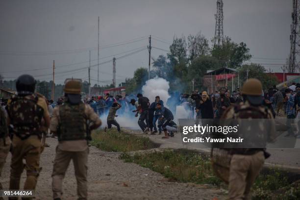 Tear gassed Kashmir protesters throw stones at Indian government forces during a protest on June 22, 2018 in Srinagar, the summer capital of Indian...