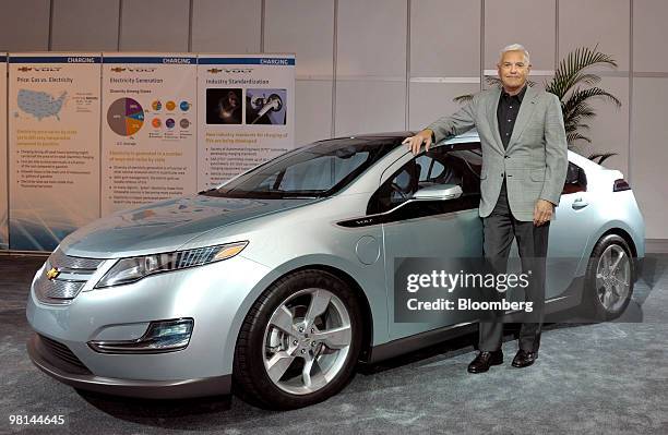 Robert Lutz, vice chairman of General Motors Co., poses with the Chevrolet Volt, a plug-in hybrid due out later this year, in New York, U.S., on...