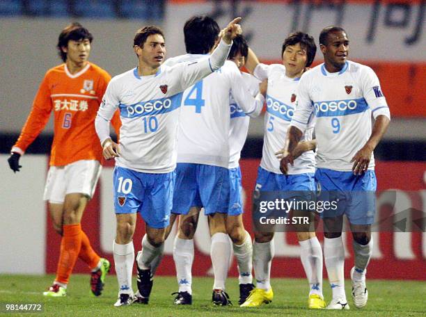 Players of South Korea's Pohang Steelers react after defeating China's Shandong Luneng FC during the AFC Champions League match in Jinan, east...