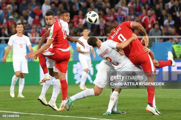 Serbia's forward Aleksandar Mitrovic is held by Switzerland's defenders during their Russia 2018 World Cup Group E football match between Serbia and...