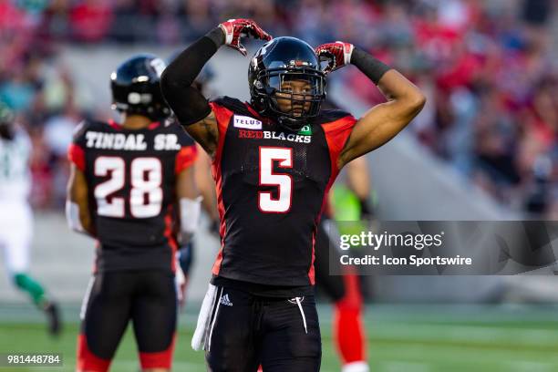 Ottawa RedBlacks defensive back Loucheiz Purifoy encourages the crowd to get loud during Canadian Football League action between Saskatchewan...