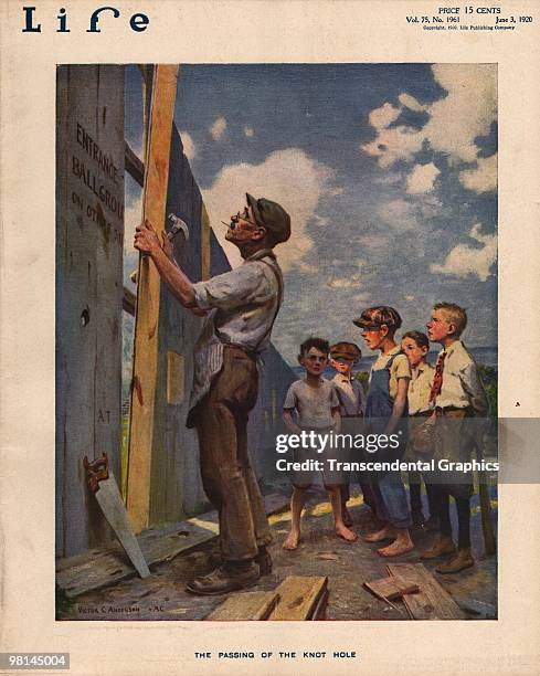 Worker repairs a plank in the outfield fence at a ballpark, preventing the knothole gang from seeing the games, on the cover of Life Magazine on the...