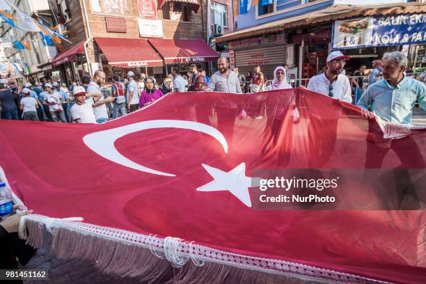 Participants in a rally in support of Recep Tayyip Erdogan, carry a Turkey flag in the streets of Istanbul. Erdogan is the candidate of the Justice...