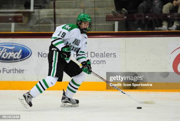 Hill-Murray Pioneers defenseman Brett Oberle carries the puck against the Centennial Cougars during a prep hockey game at Ridder Arena in...