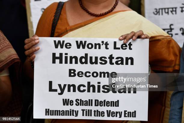 Members of All India Students Association hold placards as they protest against the mob lynchings in the country, at Parliament street, on June 22,...