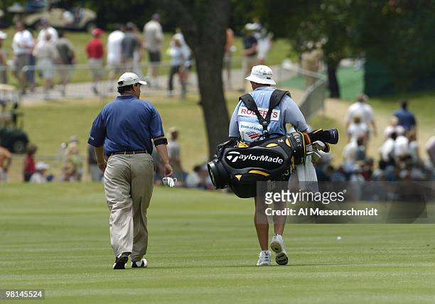 Loren Roberts walks the fairway with his caddy in the final round of the PGA Tour Bank of America Colonial in Ft. Worth, Texas, May 23, 2004.