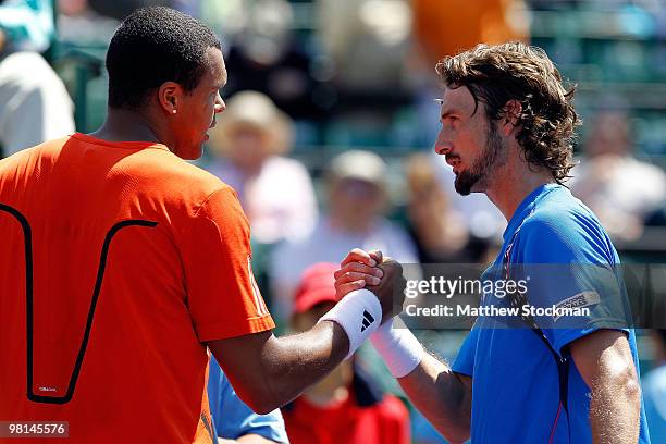 Juan Carlos Ferrero of Spain shakes hands with Jo-Wilfried Tsonga of France after their match during day eight of the 2010 Sony Ericsson Open at...