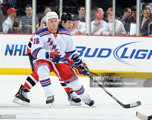 Sean Avery of the New York Rangers faces off against David Clarkson during the third period at the Prudential Center on March 25, 2010 in Newark, New...