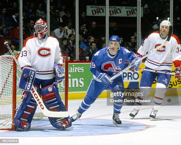 Joe Sakic of the Quebec Nordiques skates in front of the net against the Montreal Canadiens in the early 1990's at the Montreal Forum in Montreal,...