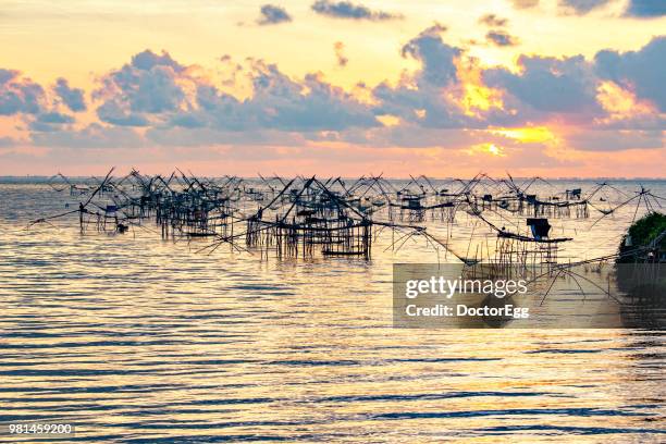 huge fishing nets in songkhla lake, pak pra fisherman village, southern of thailand - doctoregg stock pictures, royalty-free photos & images