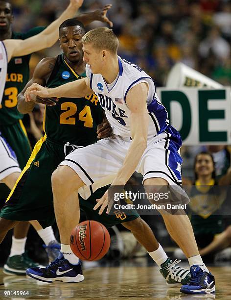 Mason Plumlee of the Duke Blue Devils moves against LaceDarius Dunn of the Baylor Bears during the south regional final of the 2010 NCAA men's...