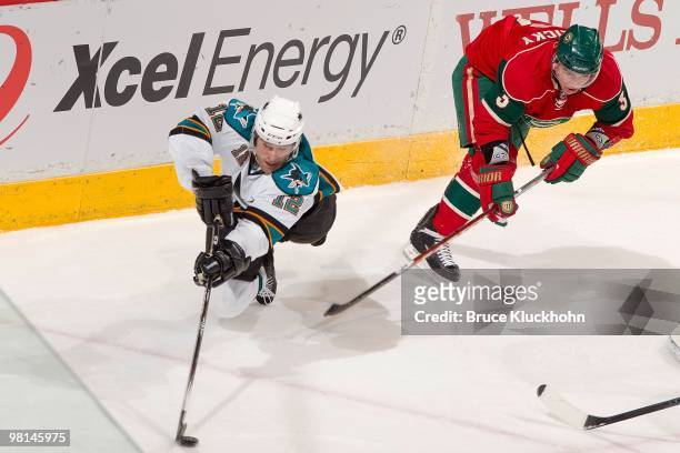 Patrick Marleau of the San Jose Sharks loses his balance while being defended by Marek Zidlicky of the Minnesota Wild during the game at the Xcel...