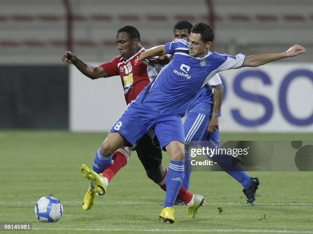 Saudi club Al-Hilal player Mirel Radoi fights for the ball with Emirati Al-Ahli club opponent Ahmed Khalil during their AFC Champions League Group D...