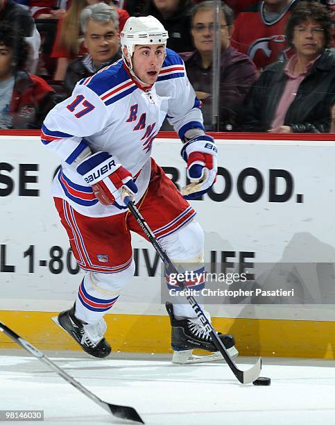 Brandon Dubinsky of the New York Rangers skates with the puck during the second period against the New Jersey Devils at the Prudential Center on...