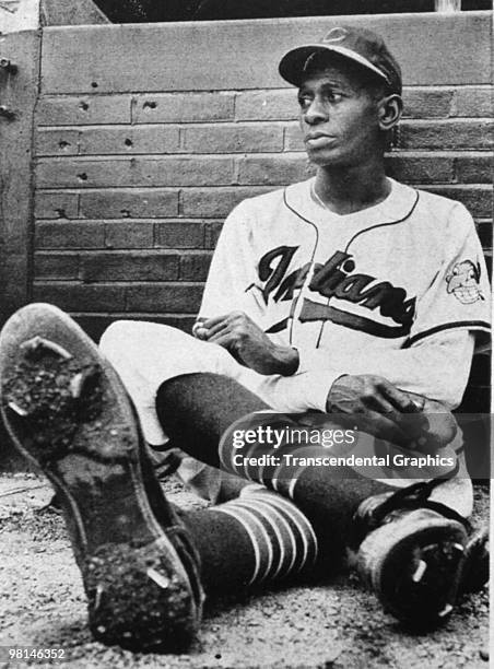 Long, tall Satchel Paige rests in the Cleveland Indians bullpen during a game at Metropolitan Stadium in Cleveland in 1948.