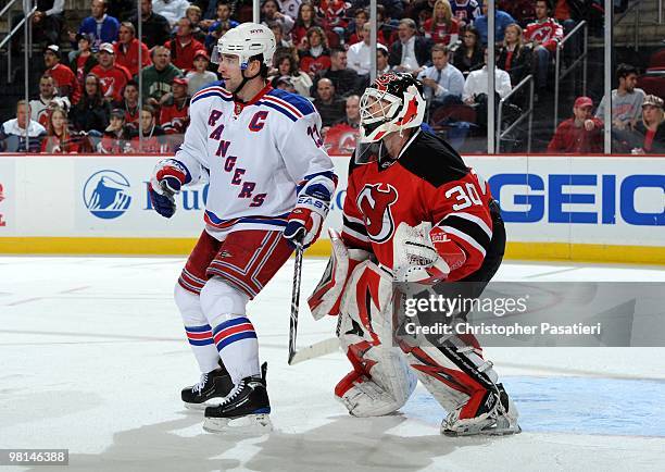 Martin Brodeur of the New Jersey Devils has his view of the game action obstructed by Chris Drury of the New York Rangers during the second period at...