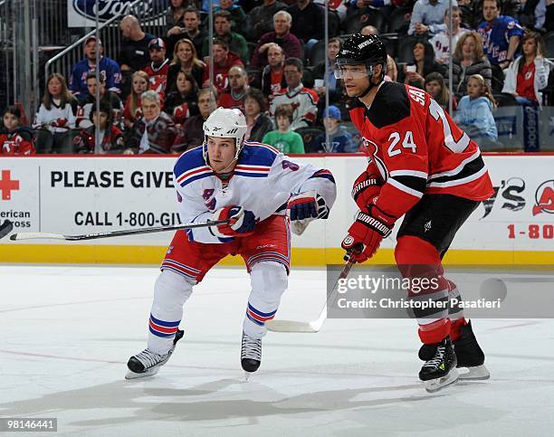 Brandon Prust of the New York Rangers faces off against Bryce Salvador of the New Jersey Devils during the second period at the Prudential Center on...