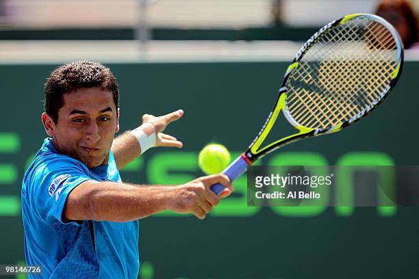 Nicolas Almagro of Spain returns a shot against Thomaz Bellucci of Brazil during day eight of the 2010 Sony Ericsson Open at Crandon Park Tennis...