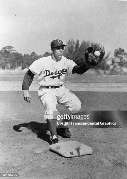 Brooklyn Dodger shortstop Pee Wee Reese takes a throw at second base during a workout at the team's spring training site at Vero Beach, Florida in...