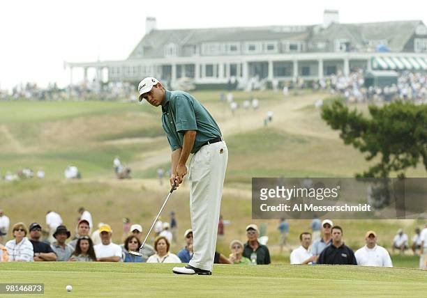 Bill Haas lines up a third-hole putt with the clubhouse in the backgroound at Shinnecock Hills, site of the 2004 U. S. Open, during third-round play...