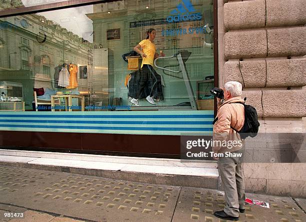 Tourist films a souvenir video as 25 Year old fitness instructor Samantha Tomlinson of Farnborough uses a training plan developed by Adidas, the...