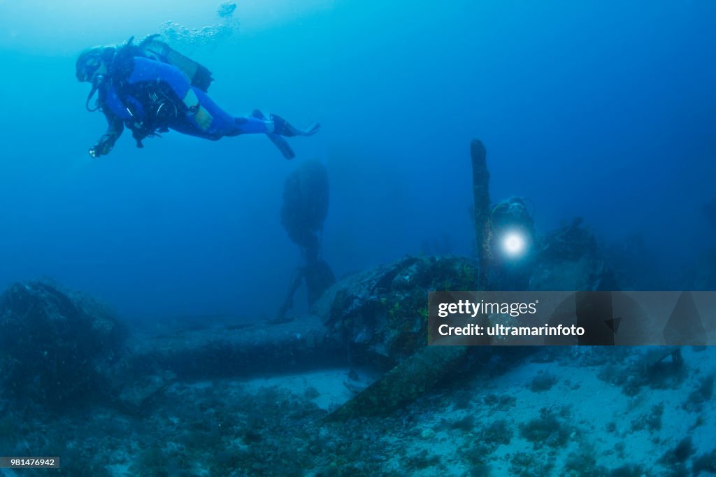 Scuba diving Exploring and enjoying Wreck diving over a B-24 Liberator Bomber Wreck Sea life Sporting women long blonde hair Water sports Scuba diver point of view. Vis, Adriatic Sea, Croatia.