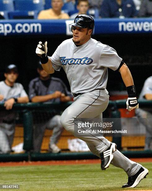 Toronto Blue Jays first baseman Eric Hinske sldies into home plate to score a run against the Tampa Bay Devil Rays April 5, 2005 at Tropicana Field.