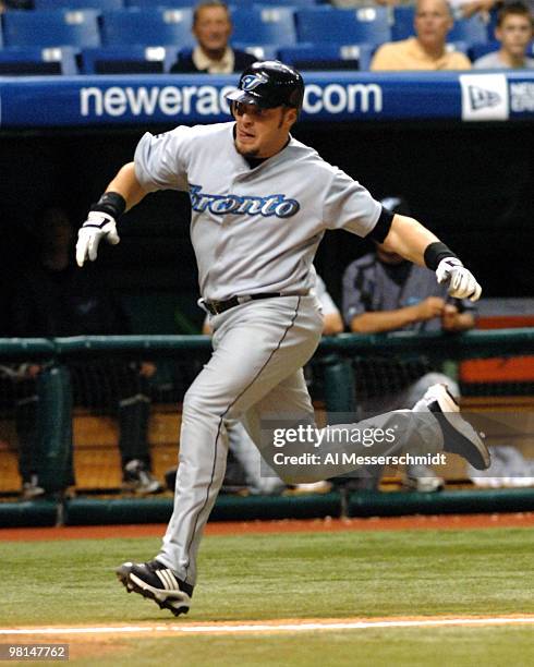 Toronto Blue Jays first baseman Eric Hinske sldies into home plate to score a run against the Tampa Bay Devil Rays April 5, 2005 at Tropicana Field.