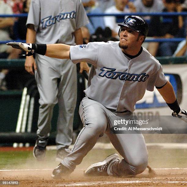 Toronto Blue Jays first baseman Eric Hinske sldies into home plate to score a run against the Tampa Bay Devil Rays April 5, 2005 at Tropicana Field.