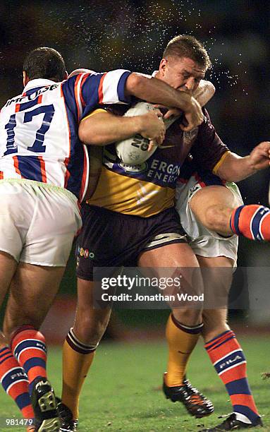 Shane Webcke of the Brisbane Broncos charges at the Newcastle Knights players Ben Kennedy and Matt Parsons during the round five match between the...