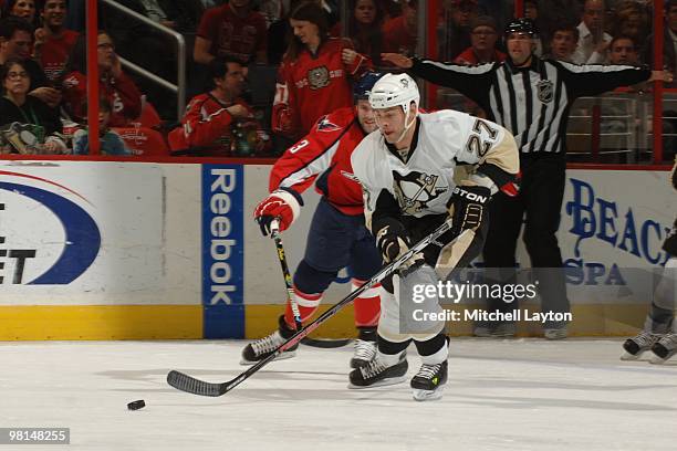 Craig Adams of the Pittsburgh Penguins skates with the puck during a NHL hockey game against the Washington Capitals on March 24, 2010 at the Verizon...