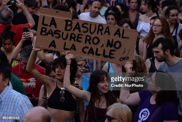 Demonstrators shout slogans and hold placard during a after a court ordered the release on bail of 'La Manada' in Madrid on 22nd June, 2018. `Trash...