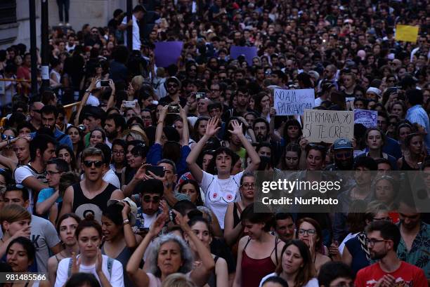 Demonstrators shout slogans and hold placard during a after a court ordered the release on bail of 'La Manada' in Madrid on 22nd June, 2018. The...